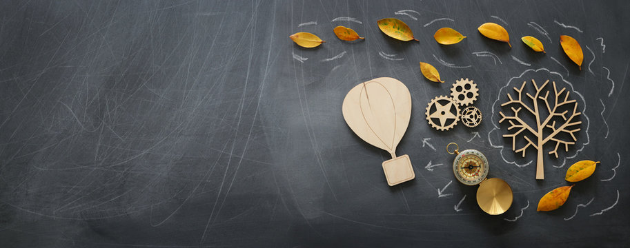 Education concept, banner of vintage air balloon on a chalkboard with fall leaves