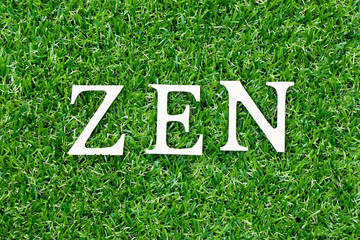 Wood letter in word zen on green grass background