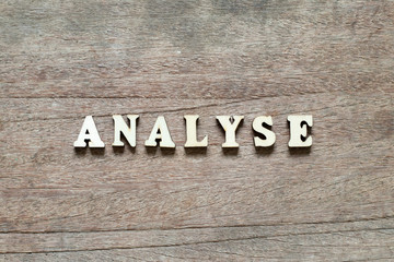 Letter block in word analyse on wood background