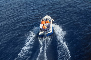 Rescue service swims quickly on a boat on the lake