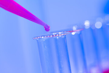 Test tube in rack and pipette media dispenser.
