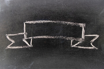 White chalk hand drawing in blank award ribbon shape on blackboard background