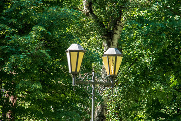 Uglich. Yaroslavl region. The Uglich Kremlin. Lanterns in the Park among the greenery