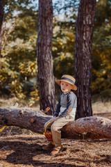 Stylish boy in a hat with a basket. boy in the park in a hat with a basket in autumn
