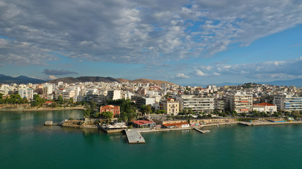 Fototapeta na wymiar Aerial drone photo of famous seaside town of Halkida or Chalkida with beautiful clouds and deep blue sky featuring old bridge connecting Evia island with mainland Greece