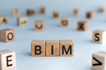 BIM - acronym from wooden blocks with letters, abbreviation BIM Building Information Modeling...