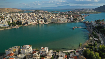 Aerial drone photo of famous seaside town of Halkida or Chalkida with beautiful clouds and deep blue sky featuring old bridge connecting Evia island with mainland Greece