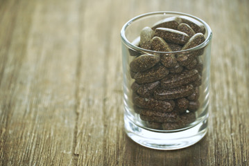 Group of supplementary food on glass lay on wood table