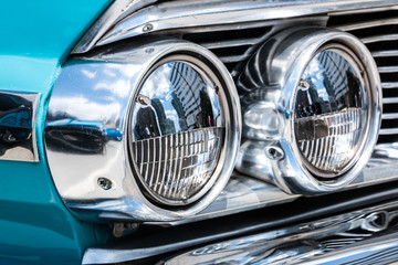 A classic blue Ford Galaxie 500 headlamp or headlight.