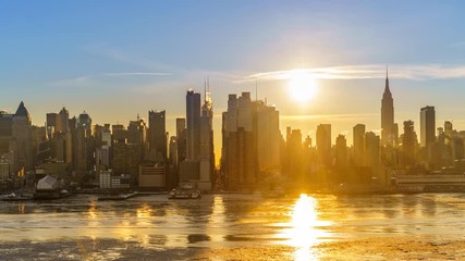 Midtown Manhattan skyline at sunrise in New York, timelapse of rising sun - Powered by Adobe