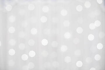 Blur photo of White christmas background with bokeh lights and snowflakes
