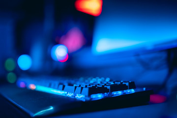 Blurred background computer, keyboard, blue and red lights. Concept eSports arena for gamer playing tournaments © Parilov