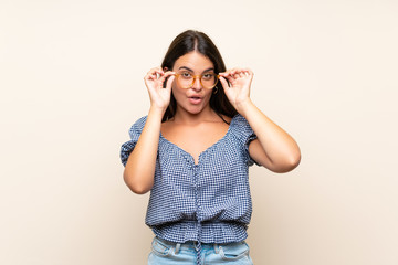 Young girl over isolated background with glasses