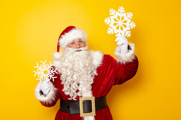 Santa Claus holding cardboard snowflakes