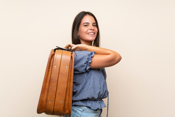 Young girl over isolated background holding a vintage briefcase