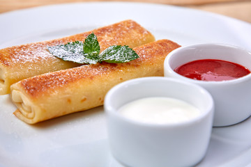 pancakes with sour cream and berry sauce