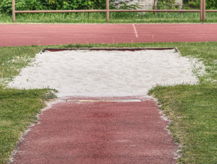 White lane for the long jump. Sandy red retrack white ake-off board.