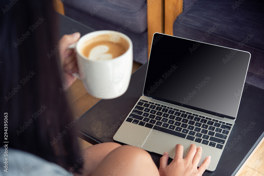 Poster business woman working on computer with empty blank screen in the coffee shop, concept freedom of wo