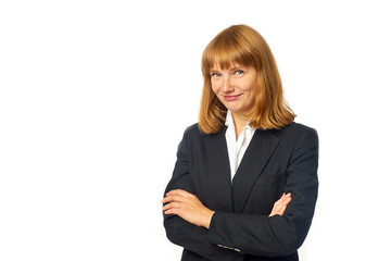 Image of young female office worker dressed in dark blazer and white shirt. Redheaded woman in business clothes looking at the camera and smiling