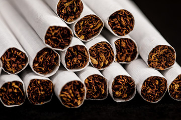 Close-up of tobacco cigarettes on a black background