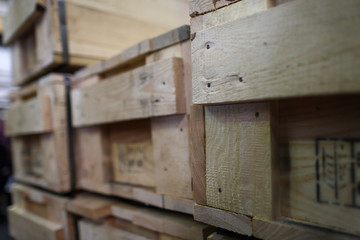 Stack of old wooden packaging boxes standing in column