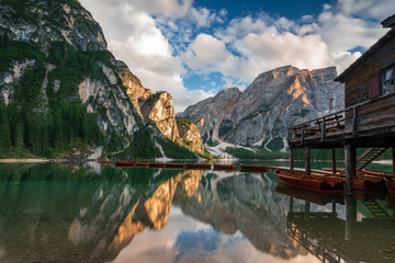 lonely child with red jacket on Lake Prags, Italy