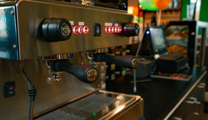 Fototapeta na wymiar Close up professional coffee machine in coffee shop. Coffee maker for make espresso, americano, latte, and cappuccino. Counter bar of coffee shop. Modern tool for barista. Beverage service business.