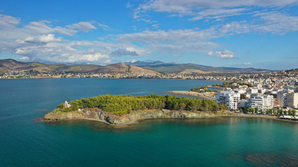 Fototapeta na wymiar Aerial drone photo of iconic lighthouse built in small islet in famous city of Halkida or Chalkida with clear water seascape and beautiful sky - clouds, Evia island, Greece