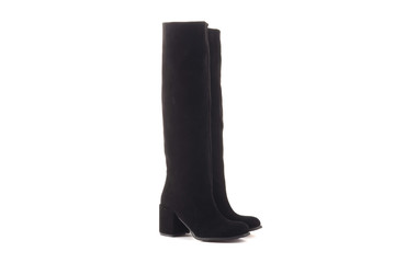 Female Legs in Classic Black and White Sneakers. Legs are Raised Upwards and Dangle from Side to Side. Grey Background. Classic Shoes. Healthy Lifestyle