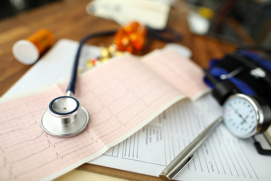 Empty GP Office With Stethoscope Head Lying At Cardiogram Paper