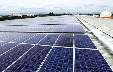 Solar PV on Industrial Roof with Cooling Tower Background