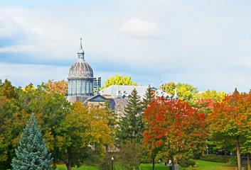 The dome of the Ursuline Convent in Trois Rivieres, Quebec, Canada, rises above trees marked with their fall colors