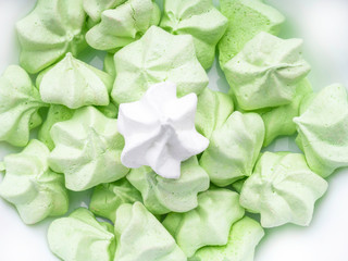 sweet and tasty mint green and white merengues, French dessert Meringue prepared from whipped with sugar and baked eggs. Horizontal orientation