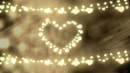 Glowing heart and strings of fairy lights on defocused background