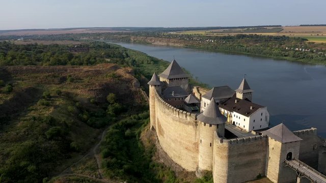Aerial view of old castle near the River. Hotyn Castle in Ukraine. Eastern Europe. Tracking from left to right.