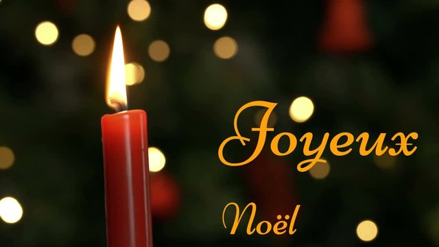Joyeux NoÃ«l written over lit candle