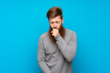 Redhead man with long beard over isolated blue background is suffering with cough and feeling bad