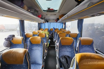 Fototapeta premium Bus interior empty seats, stop on a long distance trip