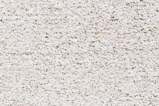 White granite crumbs decorative stucko wall texture background.