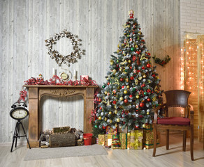 Beautiful brown Christmas interior with Christmas tree, wood fireplace and armchair