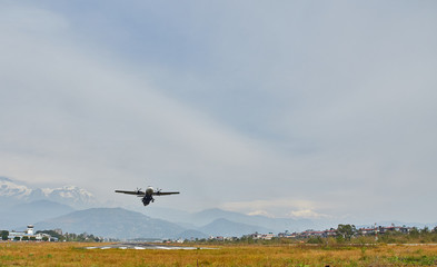 Fototapeta na wymiar A plane of local, Nepalese airlines on the runway of the airport in Pokhara is preparing for take-off