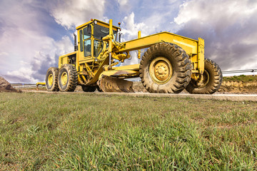 Obraz premium Excavator to level and smooth the land in the construction of a road