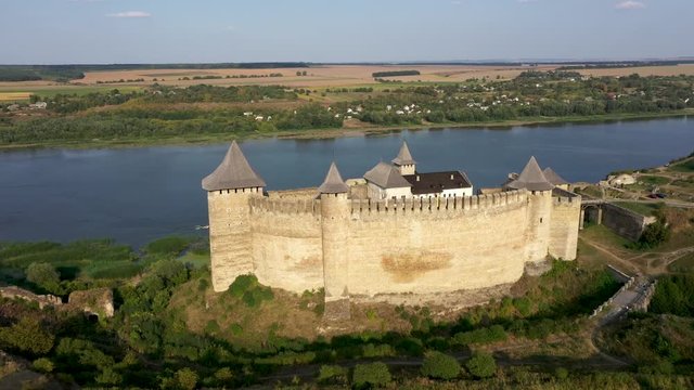 Aerial view of old castle near the River. Hotyn Castle in Ukraine. Eastern Europe. Tracking from left to right.