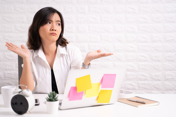 Portrait of a confused woman sitting at office