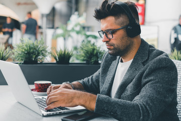 Young beard man using laptop on office, freelance work, outdoor close up hipster portrait, brutal,...
