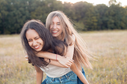 Two happy young women having fun outdoors. Best friends
