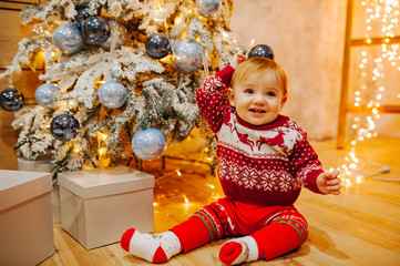 Happy fun child paying at home on Christmas time. Xmas holiday concept