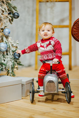 Happy fun child paying with little car at home on Christmas time. Xmas holiday concept