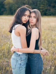 Two girls hugging on the field. Best friends