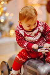 Happy fun child paying with little car at home on Christmas time. Xmas holiday concept
